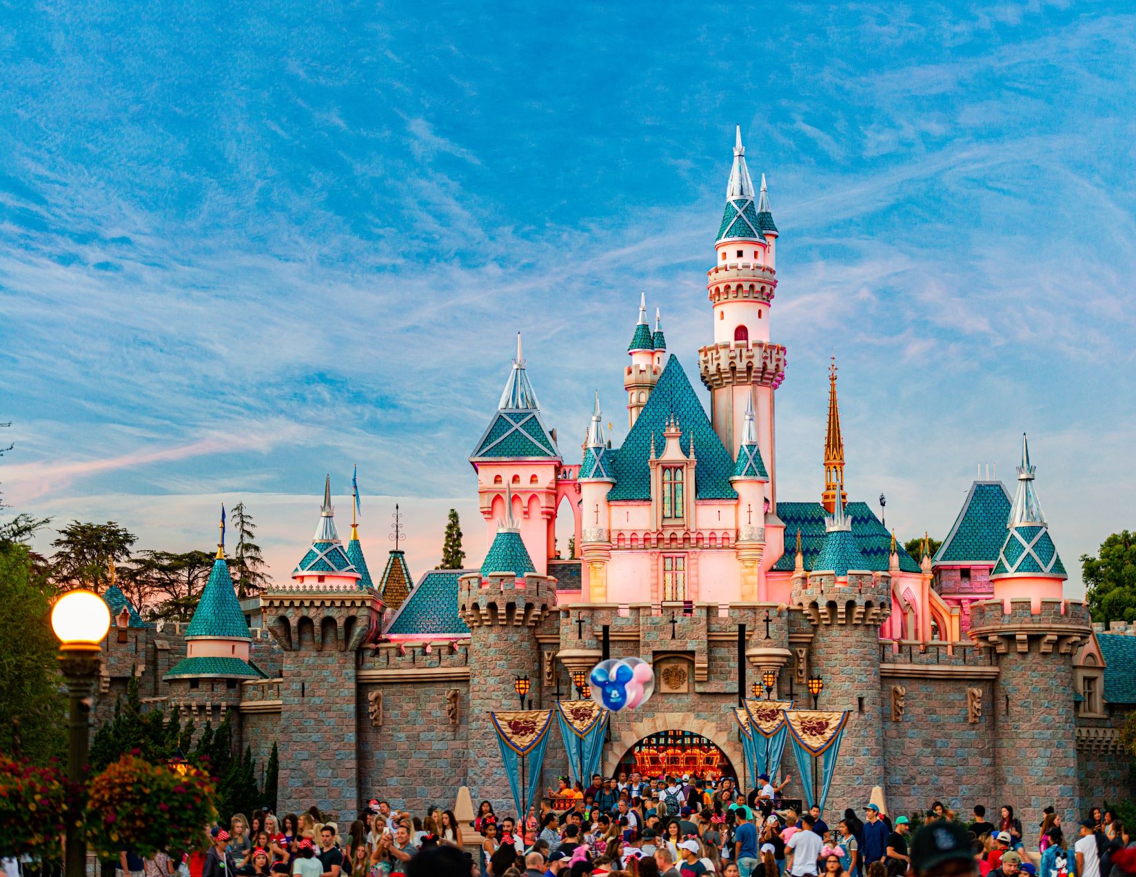 Disneyland สวนสนุกระดับโลกมีวิธีสรรหาและบริหารคนอย่างไร HIGHLIGHTS ดิสนีย์แลนด์คือสวนสนุกระดับโลกที่ได้ชื่อว่าเป็น​ “ดินแดนแห่งความฝัน” มีพนักงานรวมกว่า 130,000 คน กระจายตัวอยู่ทั่วโลก ทำให้เกิดคำถามว่าดิสนีย์สามารถบริหารทรัพยากรบุคคลที่มากขนาดนี้ให้มีทัศนคติเดียวกัน และทำสวัสดิการให้คนส่วนมากพอใจได้อย่างไร ดิสนีย์เชื่อว่าคนคือผู้สร้างสถานที่และไม่ว่าผู้บริหารจะมีมุมมองที่สวยหรูเพียงใด แต่ถ้าคนไม่มีความพร้อมในการนำเสนอแผนงานนั้น ดิสนีย์แลนด์ก็จะไม่มีวันเป็นจริง ดังนั้นดิสนีย์จึงให้ความสำคัญกับการพัฒนาคนอย่างเข้มข้นโดยตั้งเป้าว่าจะต้องทำให้เหนือกว่าที่คนทั่วไปคาดหวังเท่านั้น ดิสนีย์แลนด์ต้องการให้คนรู้ว่าแม้ภาพแสดงภายนอกจะสวยงามแค่ไหน แต่จริง ๆ ดิสนีย์แลนด์ก็คือองค์กรหนึ่งที่มีทั้งข้อดีและข้อเสีย และสิ่งที่บางคนชอบ อาจเป็นสิ่งที่อีกคนไม่ชอบก็ได้ ดังนั้นดิสนีย์จะชี้ให้ผู้สมัครงานเห็นองค์กรในทุกแง่มุมเพื่อป้องกันการผิดหวังซึ่งอาจนำไปสู่การลาออกและทำให้บริษัทต้องเสียทรัพยากรเพิ่มเติมโดยไม่จำเป็น บริษัททั่วไปสามารถนำมุมมองของดิสนีย์แลนด์มาปรับใช้ได้เลย เพราะที่นี่ไม่ได้จำกัดตัวเองอยู่แค่การเป็นสวนสนุกเท่านั้น แต่เป็นเหมือน “เมืองตัวอย่าง” ที่ตอบเราว่าการบริหารคนให้ดีจะทำให้เกิดความสุขได้อย่างไร ถ้าพูดถึงคำว่าสวนสนุกระดับโลกที่ใคร ๆ ก็ฝันอยากจะไปเยือนสักครั้ง เราเชื่อว่าชื่อของดิสนีย์แลนด์ (Disneyland) สวนสนุกที่ได้ชื่อว่าเป็น “ดินแดนแห่งความฝัน” ย่อมถูกพูดถึงเป็นชื่อแรก ๆ แน่นอน ทั้งด้วยความแข็งแรงของตัวละครอย่างมิกกี้ เมาส์, มินนี่ เมาส์, โดนัลด์ ดั๊ก และอีกมากมายที่เติบโตมาพร้อมกับวัยเด็กของเรา ตลอดจนเครื่องเล่นระดับโลกที่ถ่ายทอดออกมาอย่างตื่นเต้นเร้าใจจนถูกนำไปต่อยอดเป็นภาพยนตร์อย่าง The Pirates of the Caribbean เป็นต้น สิ่งเหล่านี้ทำให้เราต้องมาตั้งคำถามว่าดิสนีย์สามารถเปลี่ยนสวนสนุกที่ดูเป็นเรื่องของเด็กให้กลายเป็นชุมชนของคนทุกเพศทุกวัยได้อย่างไร ตลอดจนมีเคล็ดลับใดบ้างที่ถูกนำมาใช้เพื่อคงความพิเศษของดินแดนแห่งนี้ตลอดระยะเวลาหลายสิบปีที่ผ่านมา ดิสนีย์แลนด์คือธุรกิจที่แตกต่างจากองค์กรที่เราเห็นได้ทั่วไปตามท้องตลาด ดังนั้นการศึกษากลยุทธ์ของพวกเขาจึงเป็นประโยชน์ต่อทีม HR ที่อยากหากฎเกณฑ์, สวัสดิการ รวมถึงนโยบายใหม่ ๆ มาปรับใช้ภายในองค์กร ดังนั้นไม่ว่าคุณจะเคยสัมผัสเสน่ห์ของสวนสนุกระดับโลกนี้ด้วยตัวเองหรือไม่ เราก็ขอชวนคุณมาร่วมเดินทางไปสู่โลกของดิสนีย์แลนด์พร้อม ๆ กัน ณ บัดนี้ ! <!--TOC--> ดิสนีย์แลนด์ (Disneyland) มีวิธีสรรหาบุคลากรอย่างไร มีคำกล่าวว่า “คนคือผู้สร้างสถานที่” ซึ่งประโยคนี้เหมาะสมกับดิสนีย์แลนด์เป็นอย่างยิ่ง เพราะปกติแล้วเป้าหมายของคนที่มาสวนสนุกคือการปลดปล่อยความเครียดให้มากที่สุด ดังนั้นทุกคนจึงคาดหวังการบริการที่ดีชนิดที่หาไม่ได้จากแหล่งอื่น ซึ่งแปลว่าหากพนักงานของดิสนีย์แลนด์ไม่สามารถทำได้ตามที่ถูกคาดหวัง ก็มีความเป็นไปได้สูงที่ผู้คนจะหันไปใช้ทางเลือกเพื่อสร้างความสุขจากที่อื่น ไม่จำเป็นต้องเสียเงินแพง ๆ กับบริการที่ไม่ตอบโจทย์ความต้องการ ดิสนีย์แลนด์เข้าใจถึงความต้องการข้อนี้ดีจึงให้ความสำคัญกับการสรรหาบุคลากรอย่างเข้มข้น ซึ่งเราแบ่งหัวข้อการเรียนรู้ได้เป็น 4 ประเด็นดังต่อไปนี้ ดิสนีย์แลนด์จะให้ความสำคัญกับตัวตนของพนักงานมากที่สุด บริษัทระดับโลกส่วนใหญ่มักใช้คำถามยาก ๆ เพื่อให้พนักงานได้แสดงฝีมือออกมามากที่สุด แต่ที่ดิสนีย์นั้นพวกเขาให้ความสำคัญกับความเป็นตัวของตัวเองของพนักงานมากที่สุด เพราะแม้ทักษะจะเป็นเรื่องสำคัญก็จริง แต่หากบุคคลดังกล่าวไม่รู้วิธีถ่ายทอดความสามารถออกมาอย่างถูกวิธีจนทำให้บรรยากาศในภาพรวมเสียหาย ทักษะเหล่านั้นก็จะหมดความสำคัญลงทันที เหตุนี้ถ้าคุณจะไปสมัครงานกับดิสนีย์แลนด์ ก่อนที่จะเข้าไปถึงคำถามยาก ๆ แบบเฉพาะเจาะจงจริง ๆ ในช่วงแรกนั้นคำถามแบบโหดที่สุดที่คุณจะได้เจอคือการถามว่า “ตัวละครของดิสนีย์ที่ชอบที่สุดคืออะไร” คำถามนี้อาจฟังดูไม่ยากสำหรับคนที่ติดตามผลงานของพวกเขาอยู่แล้ว แต่สำหรับคนที่ไม่ได้ทำการบ้านและไม่ได้ชอบดิสนีย์แต่เพียงสมัครเข้ามาเพราะผลประโยชน์บางอย่าง คำถามนี้จะช่วยคัดคนเหล่านั้นออกไปโดยปริยาย เพราะดิสนีย์มีแนวคิดว่าพนักงานในทุกระดับตั้งแต่ล่างสุดจนถึงผู้บริหารจำเป็นต้องเจ้าใจภาพรวมด้านปรัชญาและวัฒนธรรมองค์กรอย่างเข้มข้นเพื่อให้แผนงานทั้งหมดลื่นไหลอย่างแข็งแรง https://th.hrnote.asia/orgdevelopment/what-is-organizational-culture-210604/ นอกจากนี้หากคุณมาสมัครในตำแหน่งงานที่ต้องพูดคุยเจรจากับแขกมากหน้าหลายตา ดิสนีย์จะพยายามใช้คำถามที่อยู่นอกเหนือจากบริบทการสัมภาษณ์งานทั่วไปเพื่อดูว่าทักษะการเลือกใช้คำและแก้ไขสถานการณ์เฉพาะหน้าของคุณเป็นอย่างไรบ้าง ซึ่งจะทำให้พนักงานลืมคำตอบที่เตรียมมาและเผยด้านที่เป็นตัวเองออกมาอย่างเป็นอิสระมากขึ้น ทำให้ทีม HR ได้คำตอบที่ซื่อสัตย์ จริงใจมากกว่าเดิม ดิสนีย์แลนด์จะบอกคุณทั้งข้อดีและข้อเสียขององค์กร ธุรกิจส่วนมากจะให้ความสำคัญกับภาพลักษณ์องค์กร (Employees Branding) เป็นพิเศษโดยเฉพาะเมื่อต้องแข่งขันแย่งชิงพนักงานมากฝีมือกับบริษัทอื่น ๆ เหตุนี้พวกเขาจึงพยายามนำเสนอแต่ด้านบวกเพื่อโน้มน้าวให้คนรู้สึกประทับใจและตัดสินใจเลือกทำงานกับองค์กร อย่างไรก็ตามวิธีนี้อาจทำให้พนักงานมองเนื้องาน “สวยงามกว่าที่ควรจะเป็น” เพราะทุกคนต่างรู้ดีว่าไม่มีที่ทำงานใดหรอกที่มีแต่ความสุขโดยปราศจากปัญหา ดังนั้นจึงไม่แปลกที่องค์กรในลักษณะนี้จะมีพนักงานหน้าใหม่ลาออกเป็นระยะด้วยเหตุผลว่าองค์กรจริง ๆ ไม่ได้สวยงามเหมือนที่พวกเขาถูก​ “ขายฝัน”​เมื่อครั้งมาสมัครงาน แต่ที่ดิสนีย์แลนด์นั้นต่างไป พวกเขารู้ดีว่าสิ่งสำคัญที่รักษาพนักงานเอาไว้กับองค์กร (Retention) คือการเปิดโอกาสให้พวกเขาเตรียมตัวรับมือกับสิ่งที่จะต้องเจอ และวิธีรับมือที่ดีที่สุดก็คือการชี้แจงตั้งแต่ต้นว่าหากเลือกมาทำงานกับดิสนีย์ ปัญหาทั้งหมดที่ต้องเจอหรือมีแนวโน้มว่าจะเกิดขึ้นมีอะไรบ้าง และองค์กรมีวิธีช่วยเหลืออย่างไร ควบคู่ไปกับการนำเสนอสวัสดิการในด้านบวกเข้าไปด้วย การนำเสนอองค์กรแบบนี้จะเป็นการดึงพนักงานลงมาอยู่ในโลกของความเป็นจริง อย่างเช่นหากเราเอาแต่นำเสนอว่าดิสนีย์เป็นบริษัทแรก ๆ ที่มีสวัสดิการดีมาก ให้พนักงานเข้างานได้ตามเวลาที่สะดวกและไม่มีการบังคับเรื่องเครื่องแต่งกาย (เป็นสวัสดิการที่มีมานานก่อนที่องค์กรส่วนใหญ่จะทำในยุคหลังโควิด-19) แต่ถ้าองค์กรไม่บอกว่านโยบายดังกล่าวอาจทำให้เส้นแบ่งระหว่างการทำงานกับเวลาพักผ่อนหายไป หรืออาจทำให้วินัยของการทำงานลดหย่อนลง พนักงานก็จะไม่มีกลไกรับมือกับเรื่องนี้อย่างที่ควรจะเป็น https://qath.hrnote.asia/questions/1117 กล่าวโดยสรุปว่าการปล่อยให้คนเข้าใจเพียงข้อดีอย่างเดียว จะทำให้คุณค่าขององค์กรลดลงเช่นกัน ดิสนีย์จึงเน้นย้ำว่าในการทำธุรกิจนั้นเราต้องสอนให้พนักงานมองเห็นข้อดี-ข้อเสียแบบรอบด้านเสมอ หากไม่อยากเสียทรัพยากรเพิ่มเติมอย่างไม่จำเป็น ดิสนีย์จะเข้าร่วม Job Fairs และมีปฏิสัมพันธ์กับเหล่านักศึกษาเสมอ นิตยสารชื่อดังอย่าง Cosmopolitan กล่าวว่าดิสนีย์คือขาประจำของอีเวนท์หางาน (Job Fair) เสมอ เพื่อรับสมัครเด็กฝึกงาน ตลอดจนพนักงานพาร์ทไทม์เพื่อวางรากฐานให้กับองค์กรในระยะยาว วิธีนี้นอกเหนือจากจะเปิดโอกาสให้เด็ก ๆ ในชุมชนใกล้เคียงดิสนีย์แลนด์มีโอกาสทำงานแล้ว ความใส่ใจตรงนี้ยังช่วยให้ดิสนีย์เข้าถึงนักศึกษาระดับหัวกะทิได้ไวกว่าองค์กรอื่น ๆ ที่ไม่ได้มีปฏิสัมพันธ์กับมหาวิทยาลัยโดยตรง ดิสนีย์เชื่อมั่นว่าคนรุ่นเก่าต้องฟังจากเด็กรุ่นใหม่ โดยเฉพาะเด็กที่เพิ่งเรียนจบซึ่งเป็นช่วงวัยที่เต็มไปด้วยมุมมองและไอเดียที่น่าสนใจ ความรู้เหล่านี้อาจนำไปสู่กลยุทธ์ที่พลิกแพลงผลประกอบการในโลกธุรกิจได้เลยด้วยซ้ำ ดังนั้นการเข้าร่วมกิจกรรมจัดหางานไม่ว่าเล็กหรือใหญ่จึงเป็นวิธีเบื้องต้นที่ทำให้เราเข้าถึงบุคล ากรที่มีศักยภาพได้โดยตรงและรวดเร็วกว่าวิธีอื่น ที่สำคัญยังสามารถทำการสัมภาษณ์เบื้องต้นภายในงานซึ่งเป็นการลดทรัพยากรที่สิ้นเปลืองได้เป็นอย่างดี ดิสนีย์แลนด์จะให้ข้อมูลกับผู้สมัครแบบมากที่สุดเท่าที่จะมากได้ เคยไหมที่คุณเปิดรับสมัครงานไปแต่ได้ผู้สมัครที่มีคุณสมบัติขัดแย้งกับสิ่งที่ต้องการ ปัญหานี้จะไม่เกิดขึ้นที่ดิสนีย์ เพราะพวกเขาจะระบุ Job Describtion อย่างละเอียดที่สุดเท่าที่จะทำได้ ส่วนหนึ่งเพราะดิสนีย์เป็นองค์กรระดับโลกที่มีผู้สมัครเข้ามาจำนวนมาก การเขียนสิ่งที่ต้องการให้ชัดเจนจึงเป็นขั้นตอนแรกที่จะช่วยให้ HR คัดเลือกคนที่เหมาะสมได้ง่ายขึ้น ยกตัวอย่างเช่นหากดิสนีย์ต้องการรับสมัครพนักงานมารับบทเป็นเจ้าชายเจ้าหญิงในดิสนีย์แลนด์ แทนที่พวกเขาจะเขียนภาพรวมกว้าง ๆ เพื่อเปิดโอกาสให้คนมาทดลองคว้าโอกาส ดิสนีย์จะเลือกใช้วิธีระบุไปเลยว่าต้องการคนที่มีอายุมากกว่า 18 ปีเท่านั้น, พูดได้หลายภาษาเท่านั้น, มีส่วนสูงมากกว่าเกณฑ์ที่กำหนดเท่านั้น หรือต้องส่งภาพถ่ายที่ปราศจากการแต่งหน้ามาเท่านั้น วิธีนี้จะช่วยลดอัตราของใบสมัครที่ไม่ตรงโจทย์ได้ดี เราสามารถสรุปรูปแบบการสรรหาบุคลากรของดิสนีย์ได้ว่าพวกเขาเน้นย้ำไปที่การให้ข้อมูลแบบครบวงจร ใส่ใจรายละเอียด และต้องการทราบข้อมูลในลักษณะเดียวกันกลับมาจากผู้สมัครเช่นกัน ข้อมูลเหล่านี้จะถูกนำไปประยุกต์ใช้ร่วมกับองค์ประกอบอื่น ๆ ภายในองค์กรจนออกมาเป็นกลไกที่ส่งผลดีต่อทั้งผู้สมัครซึ่งอาจเป็นพนักงานในอนาคต และผู้บริหารเองในภาพรวม ดิสนีย์แลนด์ (Disneyland) มีวิธีบริหารจัดการคนอย่างไร เมื่อผ่านขั้นตอนการสรรหามาแล้ว สิ่งที่ดิสนีย์ต้องให้ความสำคัญตามมาทันทีก็คือการบริหารจัดการพนักงานในมือที่มีรวมกว่าแสนคนกระจายตัวอยู่ทั่วโลก ดิสนีย์ต้องการทำให้พนักงานทุกคนอยู่ด้วยความสุข เพราะความสุขคือรากฐานสำคัญที่จะทำให้ดิสนีย์ในฐานะสื่อบันเทิงสามารถถ่ายทอดพลังบวกออกไปได้อย่างที่ทุกคนคาดหวัง UK Essays ได้ทำการศึกษาเรื่องระบบพัฒนาบุคลากรของดิสนีย์และพบว่าดิสนีย์ให้ความสำคัญกับการเพิ่มทักษะให้พนักงานมากเป็นพิเศษ สอดคล้องกับอัตราการเลื่อนตำแหน่งที่เน้นสร้างคนในมากกว่าจ้างคนนอก ซึ่งทั้งหมดเกิดขึ้นภายใต้แนวคิดของวอล์ท ดิสนีย์ (Walt Disney) ผู้ก่อตั้งที่กล่าวว่า “คุณสามารถฝันถึงการสร้างสถานที่ที่สวยงามที่สุดในโลก แต่มันจะเป็นจริงได้ก็ด้วยน้ำมือของมนุษย์เท่านั้น” เหตุนี้จึงไม่แปลกหากดิสนีย์จะมีแนวทางพัฒนาบุคคลที่เข้มข้นเกินกว่าที่คนทั่วไปจะนึกถึง ลูกจ้างทุกคนในดิสนีย์แลนด์จะถูกเรียกว่า Cast (ตัวละคร) ซึ่งบริษัทมีกระบวนการสร้างพนักงานตั้งแต่วันแรกที่เข้ามาสัมภาษณ์ โดยผู้ให้สัมภาษณ์ทุกคนจะต้องดูคลิปวีดีโอขนาดสั้นเพื่อให้เข้าใจว่าปรัชญาของดิสนีย์คืออะไรและพวกเขาคาดหวังถึงสิ่งใด จากนั้นหากผู้ถูกสัมภาษณ์ได้รับเลือกเข้ามาเป็นพนักงาน ก็ต้องเข้าร่วมการฝึกเบื้องต้นเป็นเวลา 1 วันครึ่งภายใต้ชื่ออบรมว่า Traditions จากนั้นก็จะเข้าสู้ขั้นตอนการศึกษาทักษะพื้นฐาน เช่นวิธีพูดจากับลูกค้า, พฤติกรรมของตัวละคร ตลอดจนวิธีแต่งกายภายใต้ชื่ออบรมว่า Disney Look ซึ่งระบุข้อมูลละเอียดมาก เช่น ขนาดของต่างหูที่ตัวละครสามารถใส่ได้ (ห้ามใหญ่กว่าที่กำหนดเด็ดขาด), สีทาเล็บที่ตัวละครสามารถทาได้ เป็นต้น ทุกคนจะถูกฝึกให้ยิ้มตลอดเวลา เพราะอย่าลืมว่าแม้ไม่มีมนุษย์คนไหนที่สดใสตลอดเวลา แต่ในเมื่องานของเราคือการสร้างความสุขให้คนดู การฝืนอารมณ์ตรงนี้ก็เป็นการเรียนรู้อย่างหนึ่งที่ภายหลังถูกเรียกเป็นศัพท์เฉพาะว่า Disney Smile และทีม HR จะเน้นย้ำกับทีมเสมอว่า “ความสำเร็จของดิสนีย์อ้างอิงอยู่ด้วยสองปัจจัยหลัก ๆ ได้แก่การใส่ใจรายละเอียด และการทำทุกอย่างให้เกินกว่าที่อีกฝ่ายคาดหวัง” ซึ่งแนวคิดนี้สามารถนำไปใช้ได้กับธุรกิจทุกประเภท พนักงาน (หรือในที่นี้ถูกเรียกว่า “ตัวละคร”) จะต้องทำหน้าที่มากกว่า 40 ชั่วโมงต่อวัน แต่ก็มีสวัสดิการมาสนับสนุนแบบเต็มที่ ไม่ว่าจะเป็นสิทธิ์ด้านการดูแลสุขภาพแบบรอบด้าน, สิทธิ์เข้าสวนสนุกและซื้อสินค้าในราคาถูก, ทุนการศึกษาและหลักสูตรพัฒนาตนเอง, แผนดูแลหลังเกษียณ รวมถึงพื้นที่พิเศษสำหรับพนักงานโดยเฉพาะซึ่งประกอบไปด้วยทะเลสาป, สระว่ายน้ำ, สนามกีฬา ฯลฯ โดยหลักสูตรพัฒนาทักษะที่มีชื่อเสียงของดิสนีย์ถูกเรียกว่า “มหาวิทยาลัยดิสนีย์” (Disney University) ที่ทำหน้าที่สอนพนักงานในทุกหัวข้อที่จำเป็นด้วยกลวิธีแบบมืออาชีพ https://th.hrnote.asia/orgdevelopment/220308-the-future-of-employee-experience/ ดิสนีย์ยังถือเป็นองค์กรที่สนับสนุนเรื่องการทำดีต้องได้รับผลตอบแทน มีรายงานว่าสวัสดิการของพนักงานในดิสนีย์แลนด์นั้นมีมากกว่า 50 แบบ และยังมีการมอบรางวัลพนักงานดีเด่นอย่างต่อเนื่อง โดยปีค.ศ.2021 ที่ผ่านมาดิสนีย์ได้มีมติปรับเงินค่าจ้างขั้นต่ำสำหรับพนักงานที่วอลต์ดิสนีย์ เวิลด์ (Walt Disney World) เป็น 15 ดอลลาร์ต่อชั่วโมง (ไม่รวมทิป) ซึ่งมากกว่าเงินเดือนขั้นต่ำที่รัฐกำหนดถึง 50% ด้วยเหตุผลทั้งหมดที่กล่าวไปนี้ทำให้พนักงานของดิสนีย์แลนด์มีอัตราการลาออกที่ต่ำหากเทียบกับธุรกิจอื่น ผู้บริหารมองเรื่องการสรรหาและบริหารคนในดิสนีย์แลนด์อย่างไร Cosmopolitans ได้สัมภาษณ์คุณโจดี้ สวีท (Jody Sweet) รองประธานฝ่ายบุคคลของดิสนีย์เพื่อหาคำตอบว่าทำไมดิสนีย์แลนด์ถึงได้รับฉายาว่า “ดินแดนที่มีความสุขที่สุดในโลก”​ และได้คำตอบว่าใครก็ตามที่มีโอกาสทำงานกับดิสนีย์จะต้องมาด้วยทัศนคติเดียวเท่านั้นคือการสร้างช่วงเวลาอันน่าจดจำให้กับผู้มาเยือนทุกคน ดังนั้นดิสนีย์แลนด์จะให้ความสำคัญกับทักษะในด้านการสื่อสารและงานบริการเป็นพิเศษ ดิสนีย์แลนด์ให้ความสำคัญกับเรื่องการเช็คประวัติ (Background Check) เพราะตัวละครต่าง ๆ ในดิสนีย์แลนด์มีจุดเด่นตรงที่สามารถมีปฏิสัมพันธ์กับแขกได้โดยตรง ดังนั้นคงไม่ใช่เรื่องดีหากพนักงานในบริษัทเคยมีประวัติอาชญากรรมหรือล่วงละเมิดทางเพศซึ่งเป็นความเสี่ยงต่อภัยอันตรายรวมถึงภาพลักษณ์ของดิสนีย์โดยรวม นอกจากนี้ดิสนีย์ยังไม่กำหนดว่าคนที่มาทำงานกับองค์กรจะต้องเป็นคนที่เก่งที่สุดเท่านั้น ดิสนีย์เชื่อมั่นในความหลากหลายทั้งเชื้อชาติ, องค์ความรู้, เพศ และมั่นใจว่าองค์ประกอบเหล่านี้จะเกื้อหนุนให้เกิดประโยชน์กับองค์กรได้ เพราะปัจจุบันความรู้มาจากผู้คนได้ทุกรูปแบบ ส่วนทางดิสนีย์เองก็มีระบบพัฒนาบุคลากรเป็นประจำ ดังนั้นตราบใดที่ทุกคนยังมองเห็นเป้าหมายเดียวกัน ภายใต้ปรัชญาเดียวกัน การก้าวเดินไปกับดิสนีย์ก็จะทำให้คุณกลายเป็นคนที่เก่งขึ้นได้แน่นอน https://th.hrnote.asia/personnel-management/improve-employee-experience/ เธอกล่าวว่าโดยปกติแล้วคำถามที่ HR ของดิสนีย์แลนด์ใช้เพื่อสัมภาษณ์พนักงานใหม่คือคำถามที่เน้นให้ผู้สมัครเล่าประสบการณ์ในชีวิตของตนเอง เพราะดิสนีย์เชื่อว่าพวกเขาเป็นองค์กรแห่งการเล่าเรื่อง (Storytelling Culture) การตอบคำถามเหล่านี้จึงสะท้อนให้เห็นว่าผู้สมัครมีความมุ่งมั่นที่จะเล่าเรื่องราวต่าง ๆ ในแง่งามและสนุกสนานที่สุดได้อย่างไร ซึ่งแม้มันจะดูเป็นคำถามธรรมดา ๆ แต่ดิสนีย์พิสูจน์แล้วว่าคำถามแบบนี้จะทำให้ผู้สัมภาษณ์มองเห็นตัวตนที่แท้จริงของผู้สมัครได้อย่างชัดเจน ขณะเดียวกันดิสนีย์ก็หวังว่าผู้สมัครจะถามคำถามกลับมาที่ HR เช่นกัน โดยเฉพาะคำถามที่เกี่ยวกับวัฒนธรรมองค์กร หรือเรื่องอื่น ๆ ที่จะทำให้เข้าใจดิสนีย์ในแง่มุมที่นอกเหนือจากภาพแสดงทางสื่อต่าง ๆ เพื่อให้แน่ใจว่าการทำงานในดิสนีย์จะตอบโจทย์ทางอาชีพ (Career Path) ที่วางเอาไว้จริง ๆ ซึ่งเธอมองว่าการถามเป็นขั้นตอนที่สำคัญมาก ใครที่เลือกอยู่เฉย ๆ หรือปล่อยให้โอกาสนี้ผ่านไปถือเป็นข้อผิดพลาดและอาจเป็นสัญญาณที่บอกว่าพวกเขาไม่ได้สนใจตำแหน่งที่สมัครเข้ามามากเท่าที่ควร ท้ายสุดนี้เธอแนะนำว่าแม้ดิสนีย์จะขึ้นชื่อเรื่องความยืดหยุ่นในการทำงานและเปิดโอกาสให้พนักงานแต่งตัวได้ตามสบาย แต่ผู้สมัครก็ควรแต่งกายแบบให้เกียรติสถานที่มากที่สุด รวมถึงแสดงออกอย่างจริงใจว่าสนใจงานของดิสนีย์จริง ๆ โดยอาจส่งอีเมลหรือข้อความมาขอบคุณทีม HR หลังจากที่การสัมภาษณ์จบลง วิธีนี้จะทำให้พนักงานโดดเด่นกว่าผู้สมัครคนอื่น ๆ หากมีการแข่งขันเกิดขึ้นนั่นเอง บทสรุป ดิสนีย์แลนด์ (Disneyland) คือองค์กรที่ตอกย้ำให้เห็นว่าแม้ทีมบริหารจะมีภาพฝันในหัวที่สวยงามเพียงใด แต่สิ่งที่จะกำหนดว่าภาพนั้นกลายเป็นจริงได้หรือไม่ก็คือทรัพยากรคนที่จะต้องให้ความสำคัญตั้งแต่ขั้นตอนของการสรรหา, บริหาร เรื่อยไปจนถึงการดูแลเมื่อพนักงานลาออกไป เพราะความสุขจะส่งต่อไปได้ก็ต่อเมื่อตัวพนักงานมีความรู้สึกแบบเดียวกันเป็นที่ตั้งเท่านั้น หลายคนมักตั้งคำถามว่าในฐานะคนทำงานแล้ว เราควรให้ความสำคัญกับเรื่องใดมากกว่าระหว่างผลประกอบการและความสุข และใช้เวลาส่วนใหญ่ไปกับการค้นหาคำตอบนั้นอย่างเคร่งเครียด แต่จริง ๆ แล้วทั้งสองอย่างนี้ต้องเดินไปพร้อมกัน เพราะแม้ความเครียดจะทำให้งานเสร็จตามเป้าหมายที่กำหนด แต่สิ่งที่สูญเสียไปแน่นอนก็คือคุณค่าทั้งในด้านร่างกายและจิตใจ ซึ่งเมื่อเวลาผ่านไปนานเข้าจะกลายเป็นเราเองที่ต้องถอยออกมาโดยไม่ได้อะไรเลย ดิสนีย์แลนด์ทำให้เรากลับมานึกถึงความสุขในการทำงานอีกครั้ง และหวังว่าจะมีองค์กรอีกมากมายที่นำองค์ความรู้และทัศนคติดี ๆ จาก “ดินแดนที่มีความสุขที่สุดในโลก” แห่งนี้ไปปรับใช้เพื่อสร้างบรรยากาศที่สวยงามในบริษัทของคุณ Sources https://bit.ly/3QyaCEq https://bit.ly/3ptLxyx https://bit.ly/3A5C7OA https://bit.ly/3STyGDc
